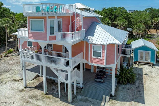 4501 Seair Ln, Upper Captiva, FL 33924 - rear view of house featuring metal roof, stairs, french doors, and a balcony