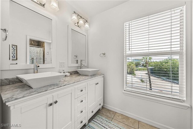 4501 Seair Ln, Upper Captiva, FL 33924 - full bathroom with double vanity, tile patterned flooring, baseboards, and a shower