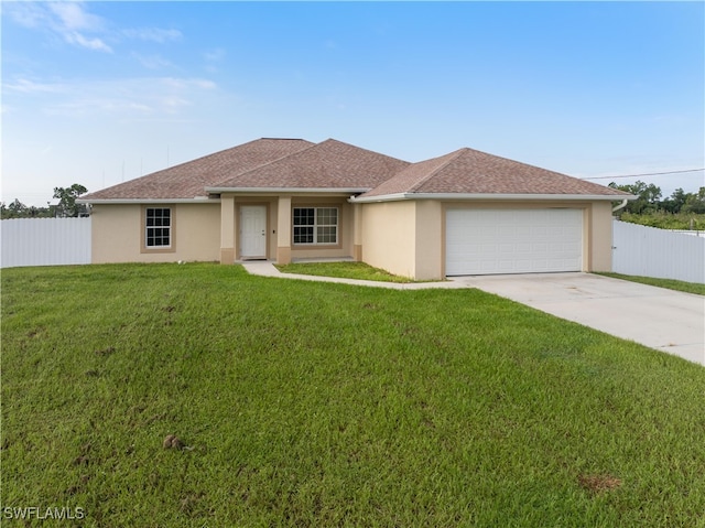 view of front of home featuring a garage and a front lawn