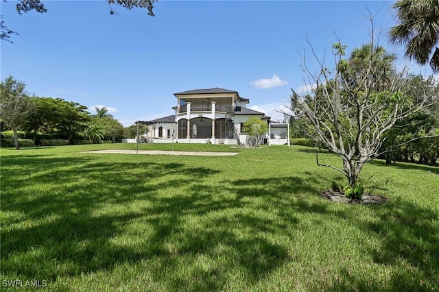 view of yard with a balcony