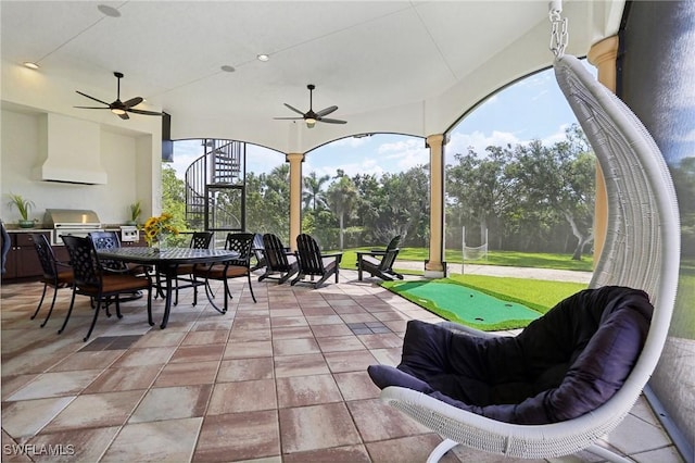 view of patio / terrace with area for grilling, ceiling fan, and an outdoor kitchen