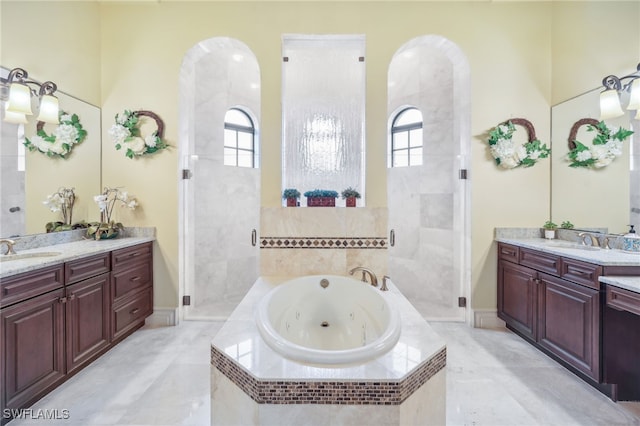 bathroom featuring independent shower and bath and vanity