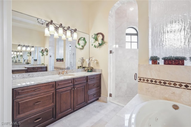 bathroom featuring vanity and separate shower and tub