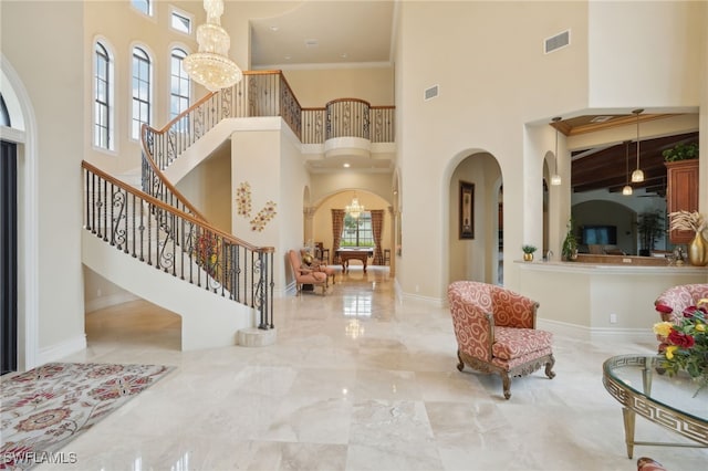 foyer entrance featuring a notable chandelier and a high ceiling