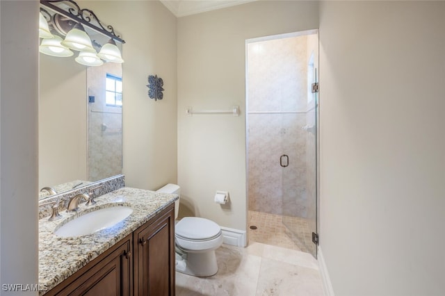 bathroom with vanity, a shower stall, toilet, and baseboards