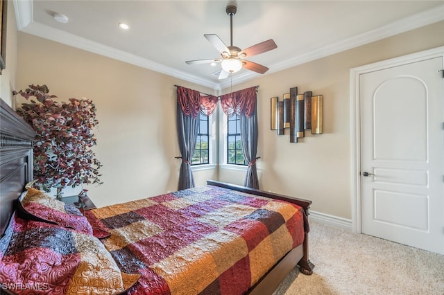 carpeted bedroom featuring a ceiling fan, crown molding, and baseboards