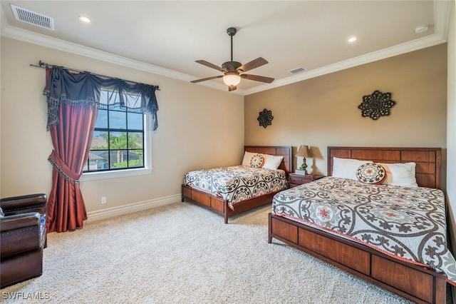 carpeted bedroom with visible vents, a ceiling fan, crown molding, and baseboards