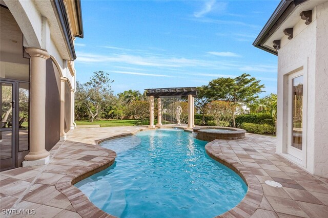 view of pool featuring a pool with connected hot tub and a patio