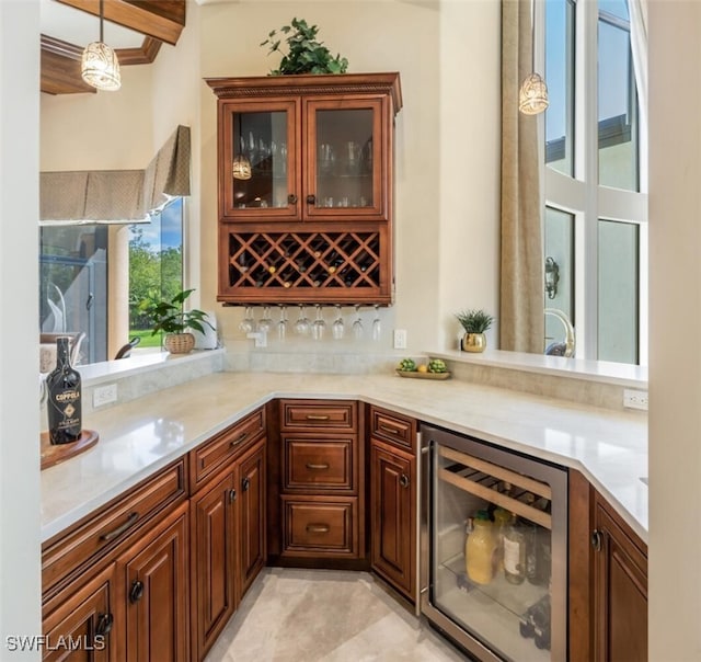 bar with wine cooler, pendant lighting, and a bar