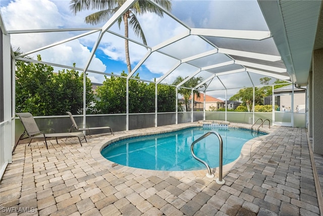 view of swimming pool with glass enclosure and a patio