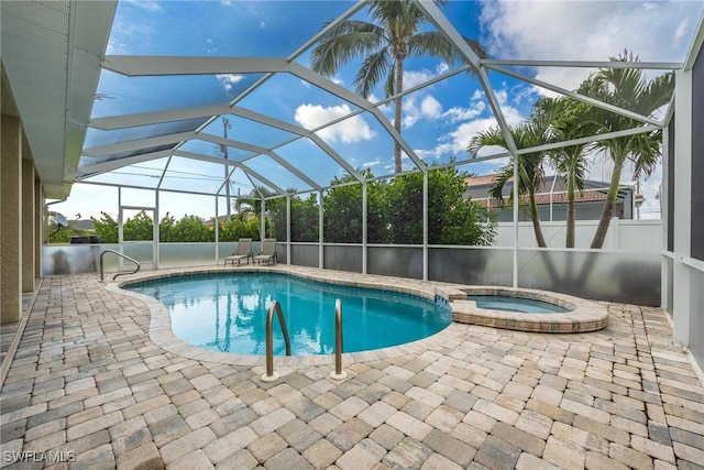 view of pool with a lanai, an in ground hot tub, and a patio area