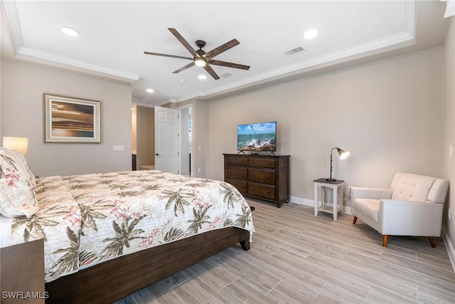 bedroom featuring ceiling fan, crown molding, and a tray ceiling