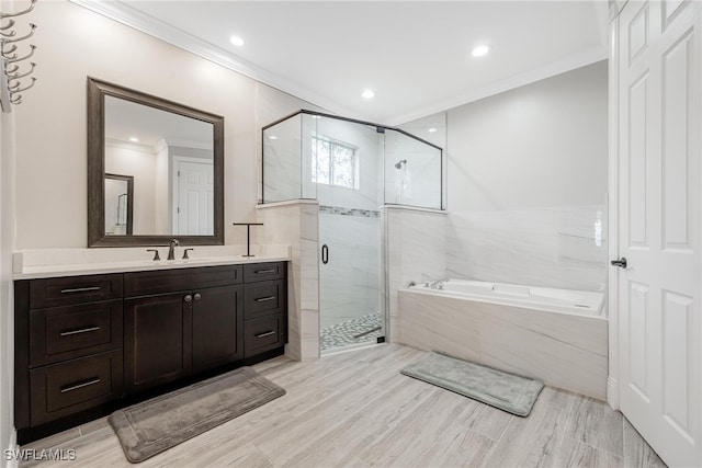 bathroom featuring crown molding, separate shower and tub, and vanity