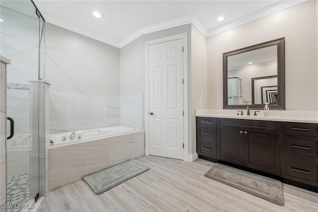 bathroom featuring crown molding, vanity, and shower with separate bathtub