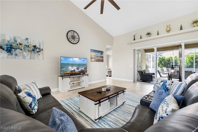 tiled living room with ceiling fan and high vaulted ceiling