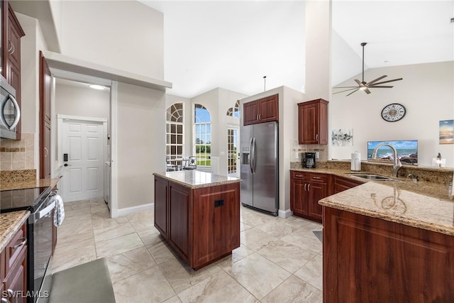 kitchen with backsplash, stainless steel appliances, high vaulted ceiling, and a kitchen island