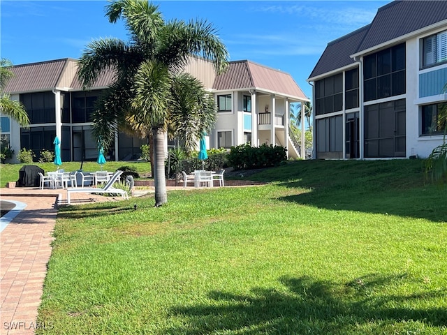 surrounding community featuring a lawn and a patio area