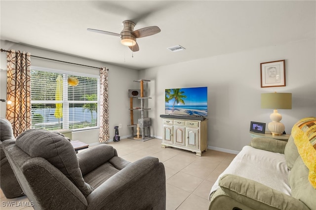 living room with ceiling fan and light tile patterned flooring