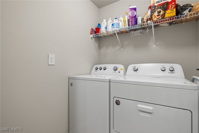 clothes washing area with washer and clothes dryer