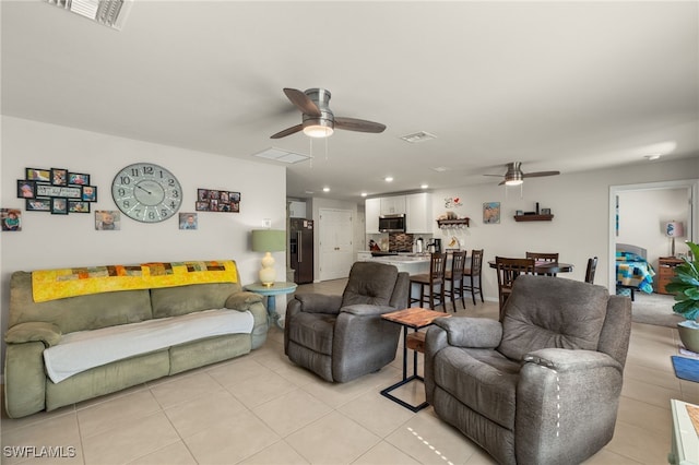 tiled living room with ceiling fan