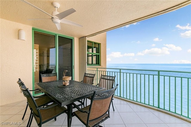 balcony featuring a water view and ceiling fan