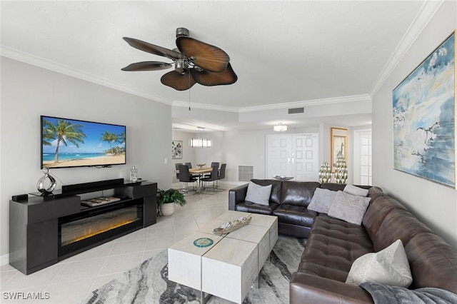 tiled living room featuring ceiling fan and ornamental molding