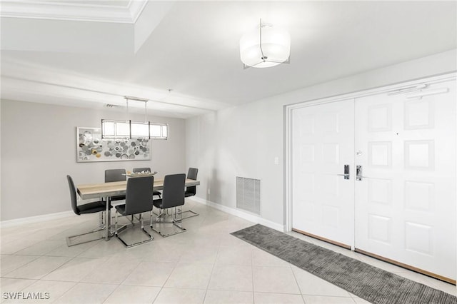 tiled dining room with ornamental molding