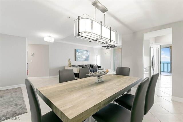 tiled dining space featuring ceiling fan