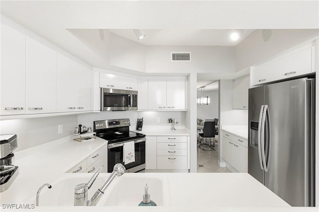 kitchen with white cabinetry, light tile patterned floors, and stainless steel appliances