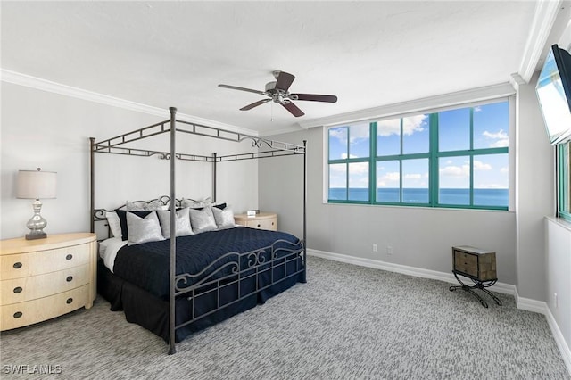 carpeted bedroom featuring ceiling fan and crown molding