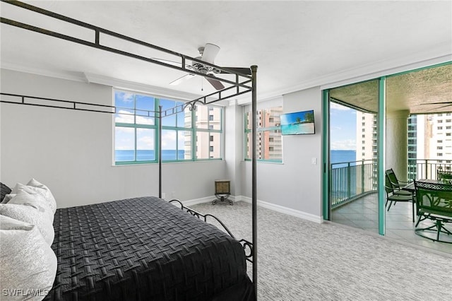 bedroom featuring access to exterior, multiple windows, ceiling fan, and crown molding