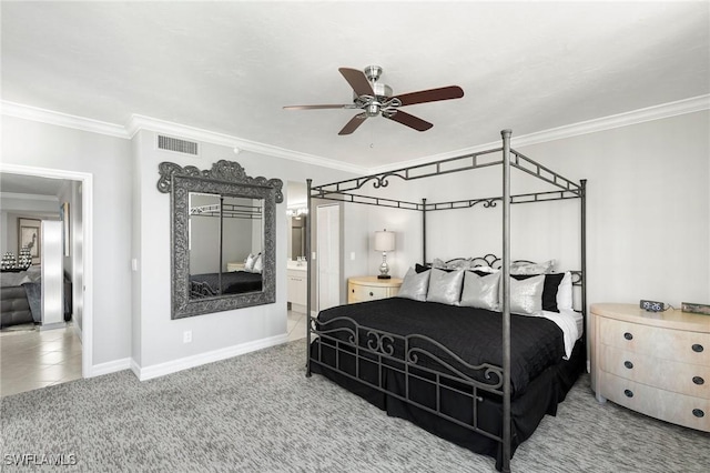 carpeted bedroom with ensuite bathroom, ceiling fan, and ornamental molding