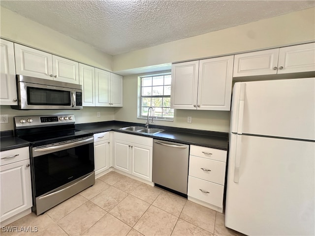 kitchen featuring sink, stainless steel appliances, and white cabinetry