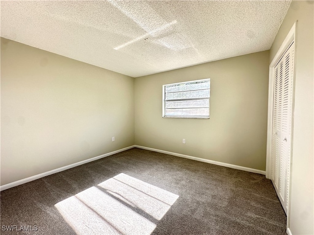 unfurnished bedroom featuring carpet flooring, a textured ceiling, and a closet