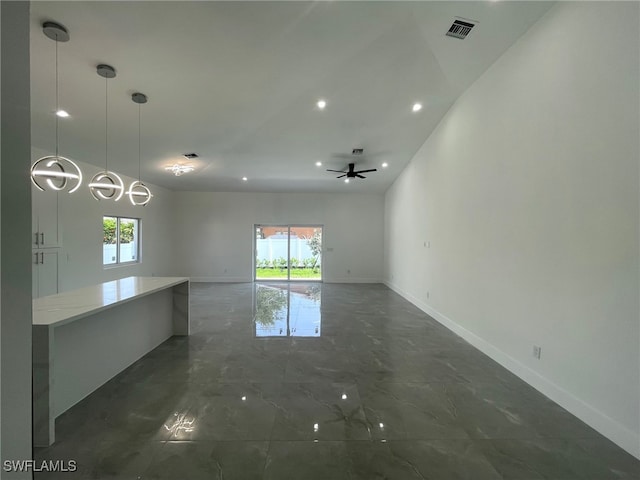 tiled empty room featuring ceiling fan