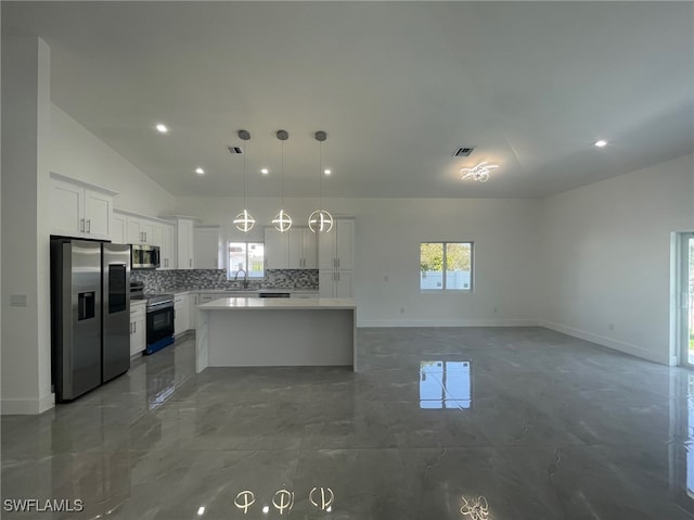 kitchen with sink, stainless steel appliances, a kitchen island, and tile patterned floors