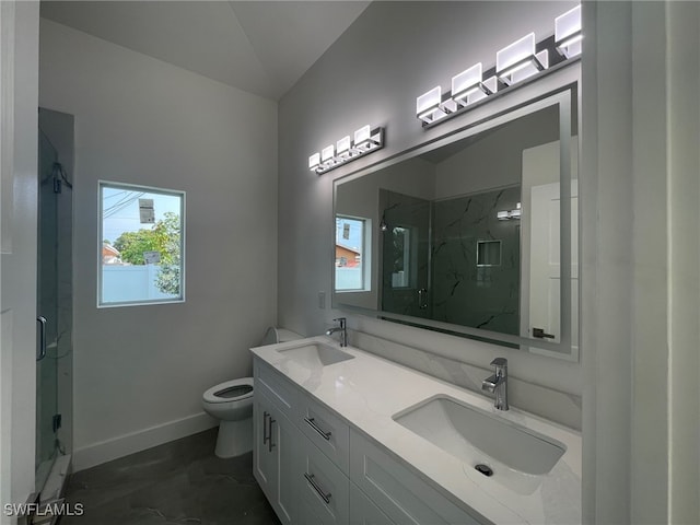 bathroom with lofted ceiling, toilet, dual bowl vanity, a shower with shower door, and tile patterned floors