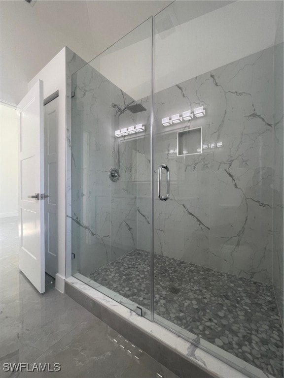 bathroom with walk in shower and tile patterned flooring