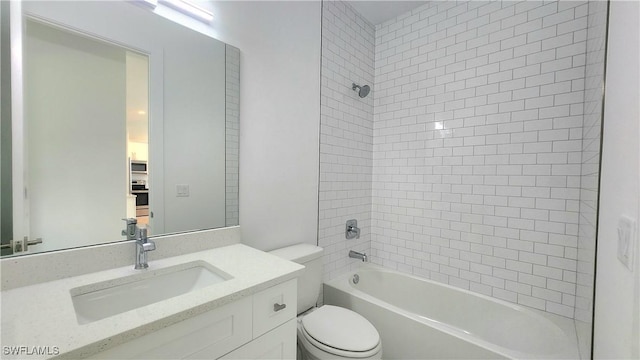 full bathroom with vanity, tiled shower / bath combo, and toilet