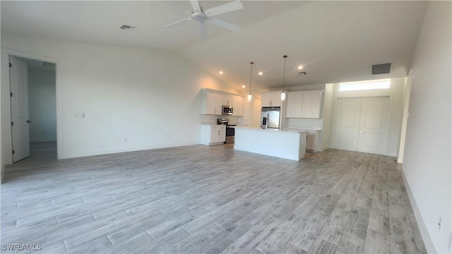 unfurnished living room featuring ceiling fan, light hardwood / wood-style floors, and vaulted ceiling