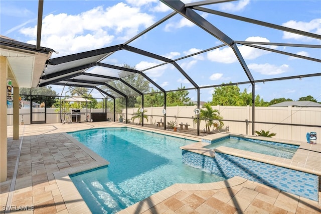 view of pool with a lanai, an in ground hot tub, and a patio