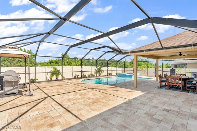 view of swimming pool with a lanai, a patio area, and ceiling fan