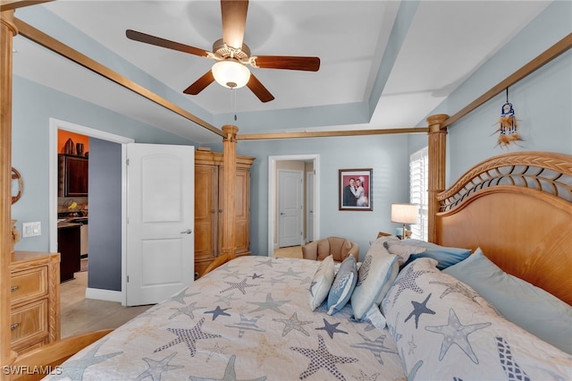 bedroom with ceiling fan, light tile patterned flooring, and a tray ceiling