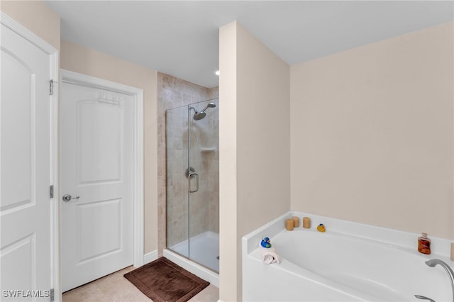 bathroom featuring plus walk in shower and tile patterned flooring