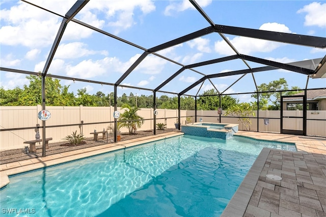 view of swimming pool featuring a lanai, an in ground hot tub, and a patio area