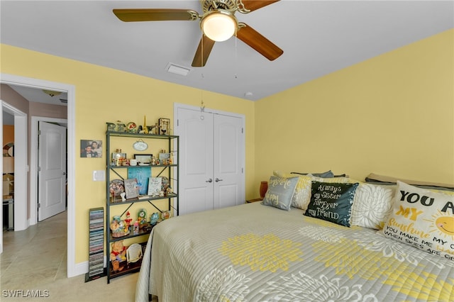 bedroom featuring tile patterned floors, a closet, and ceiling fan