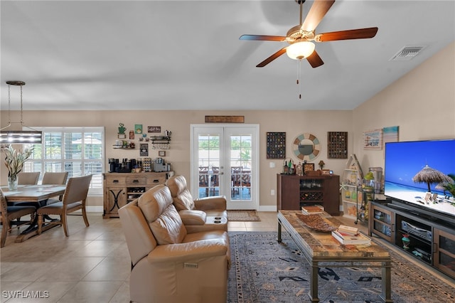 tiled living room with ceiling fan and french doors