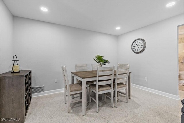 dining space featuring light colored carpet