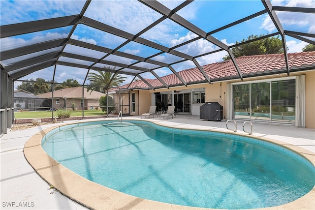 view of pool with a patio area and a lanai