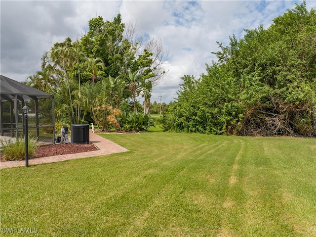 view of yard featuring glass enclosure